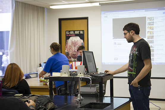 Anthropology Society president Matthew James, right, sets up the projector for an episode of Doctor Who, part of an event the club held based on the cult classic. 