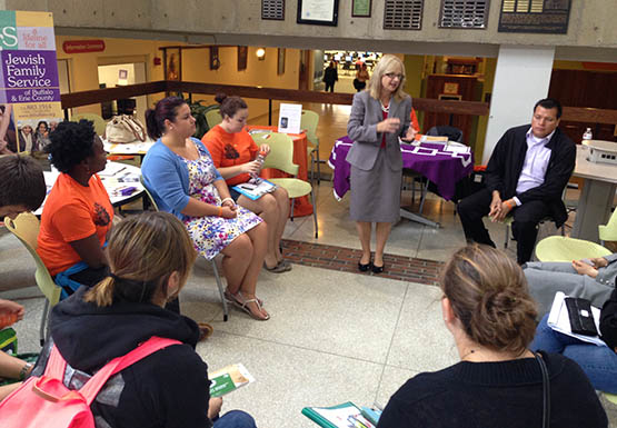 Susan McCartney speaks to a group of students and community leaders at the Community Engagement Center.