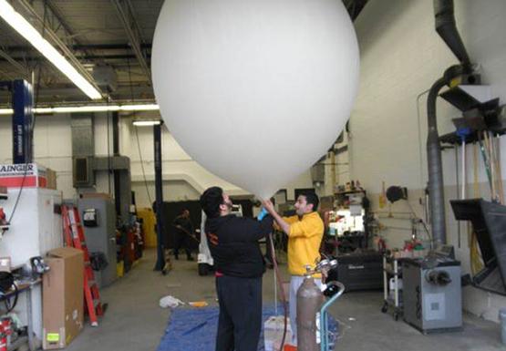 Edward Bryant, left, and Mike Al-Zoubi get ready to launch their balloon, Bengal I, part of a final project for a physics class. The balloon captured photos of the curve of the Earth.