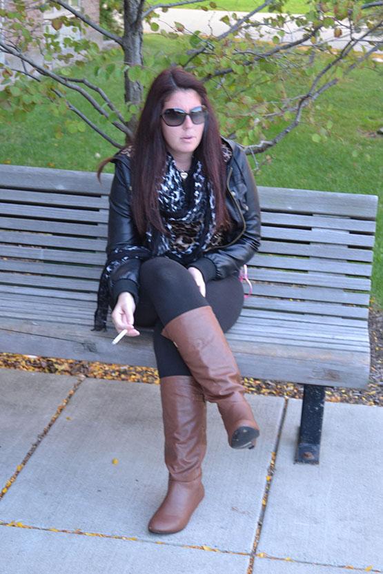 Rebecca Scaccia smoking on a bench outside Bulger.