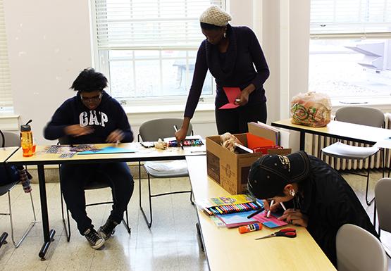 Crystal Smith, left; Joella Zukwiya, center; and Zeth Lew, right, help create holiday cards for military members across the nation as part of Holiday Cards for Heroes.