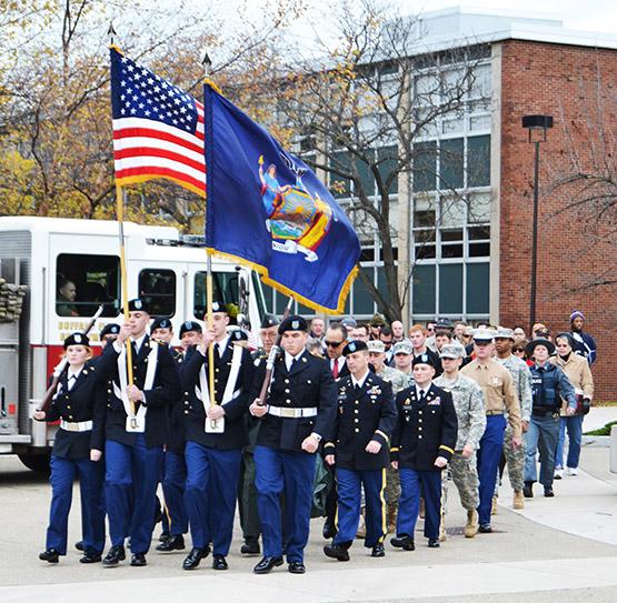 Student veterans, past and present military members march in silence through the Union Quad in honor of service