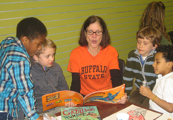 A volunteer reads to children during Peace Love and Grant Street 2012.