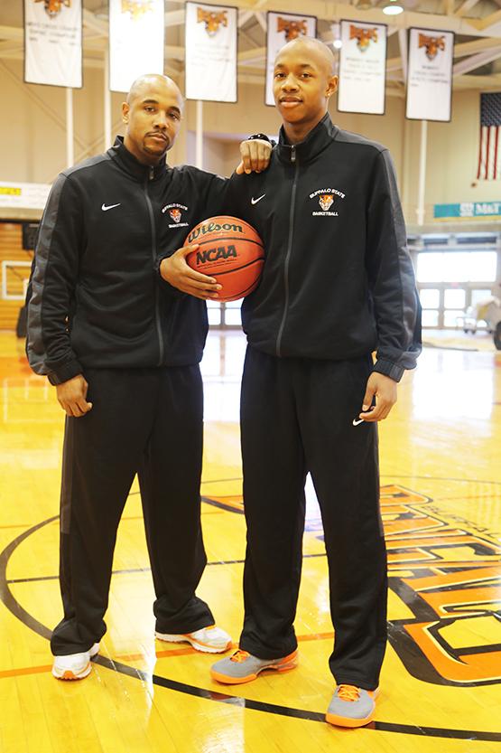 Mens basketball guard Jordan Glover (right) stands with his father, assistant coach Kevin Glover (left).