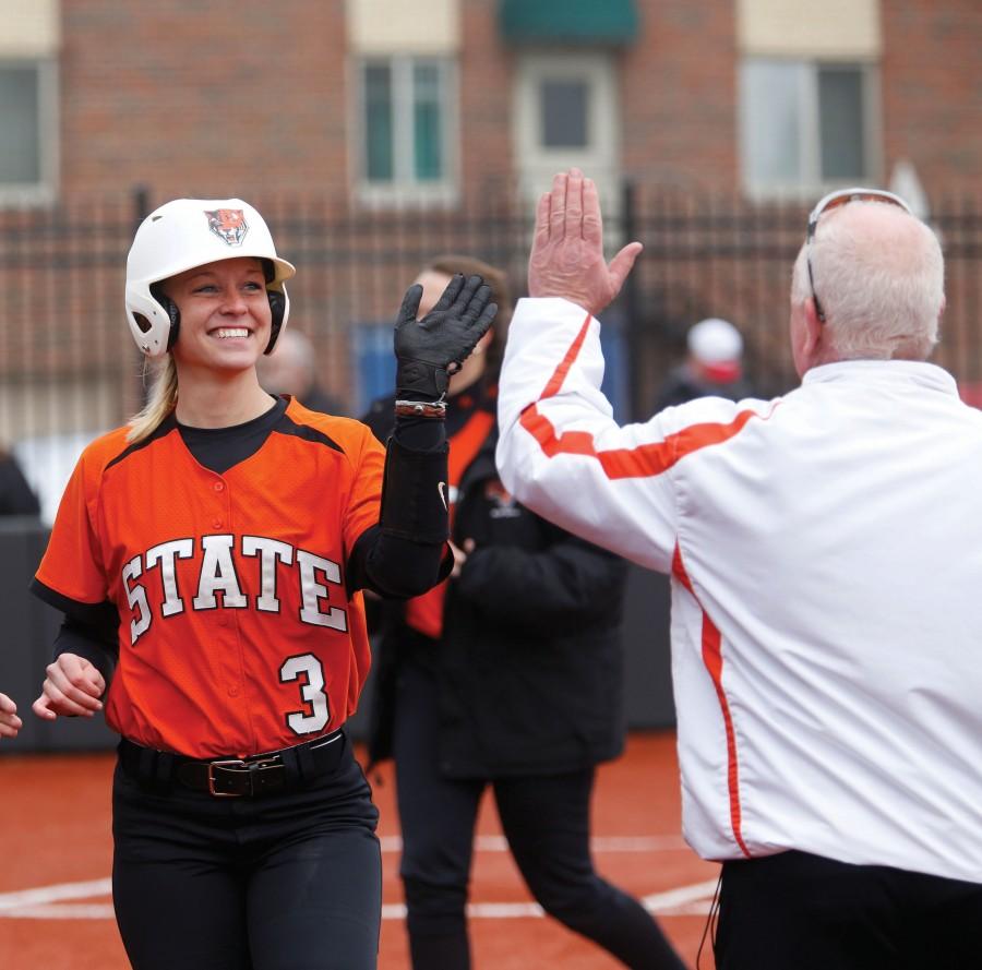 Senior Joanna Bardak high-fives assistant coach Greg Willats after hitting a go-ahead home from against Plattsburgh