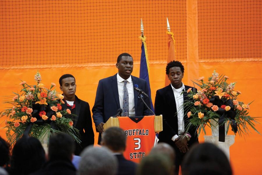 Peter Murphy (center), president of the Caribbean Students Organization, speaks during a memorial service held last Wednesday for Bradley Doyley.