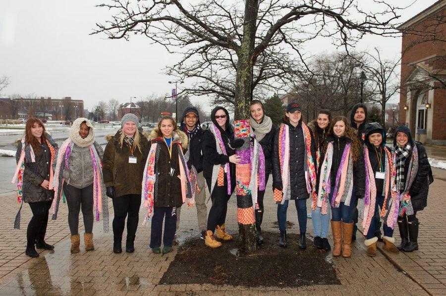 Volunteers gather to wrap trees on Commencement Walk to raise awareness of the Student Philanthropy Councils campaign to restore campus arboretum.