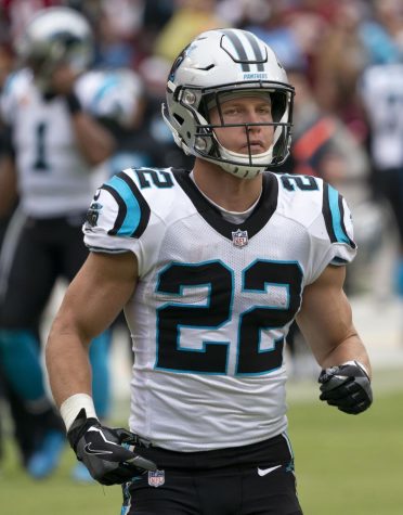 Running back Christian McCaffery standing on a football field