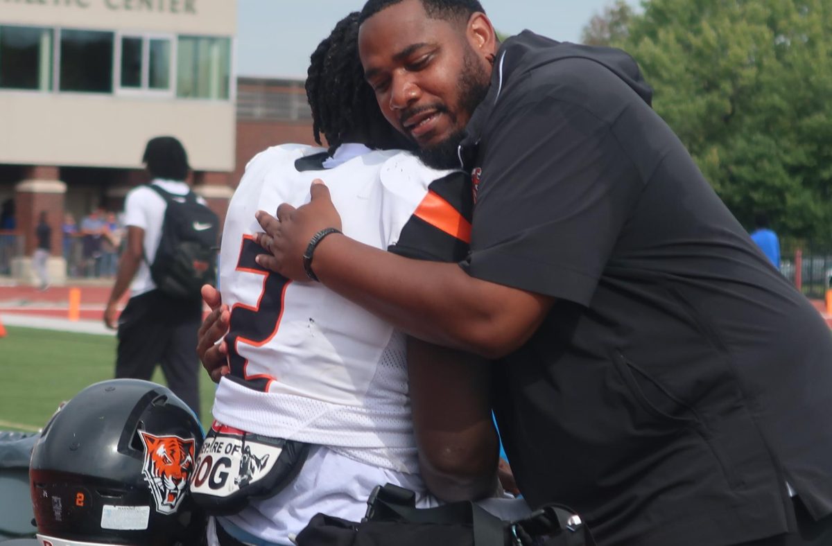 Bengals Head Coach Lazarus Morgan and running back Chris Boadi embrace following the teams first win of the season.