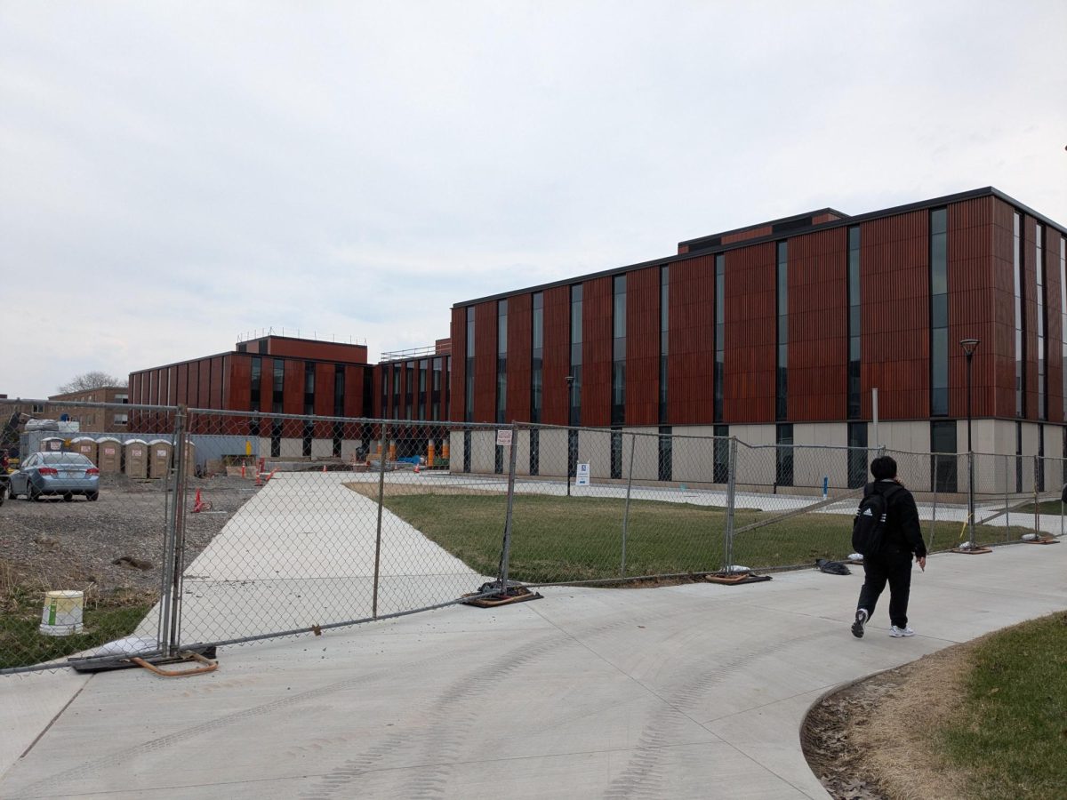 Elms Hall and its construction border on a recent, blustery afternoon. 